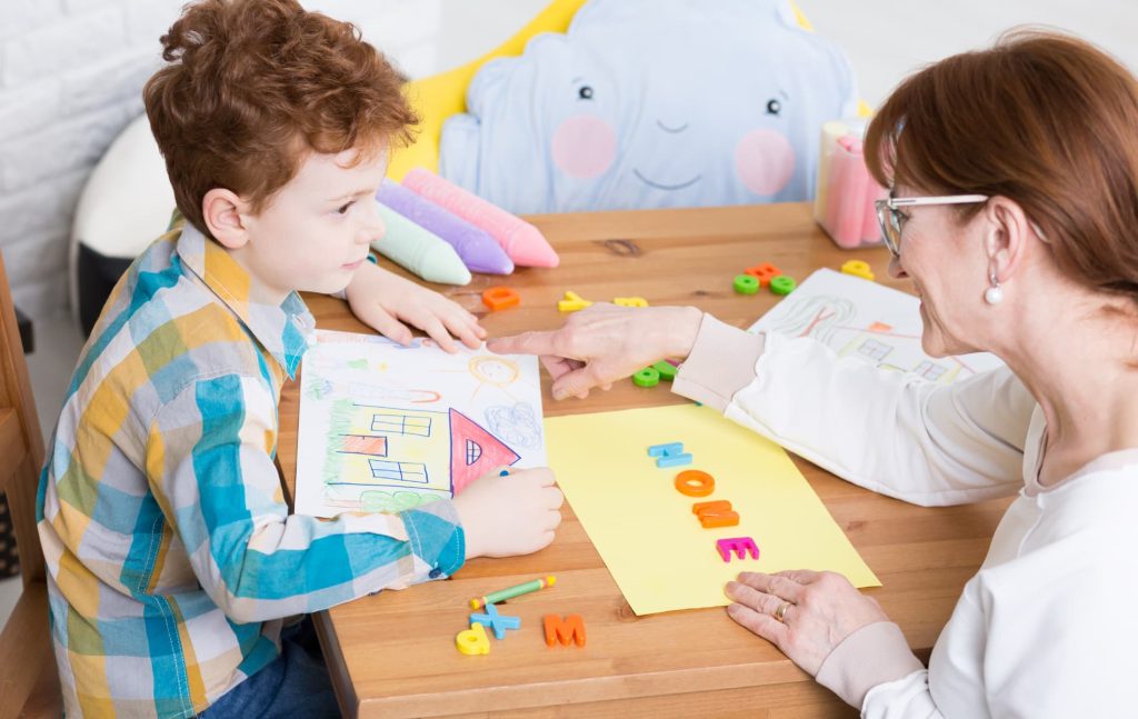 speech therapist and young boy in speech therapy session