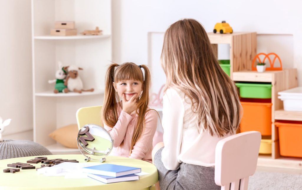 speech and audio pathologist assessing girl's speech and audio